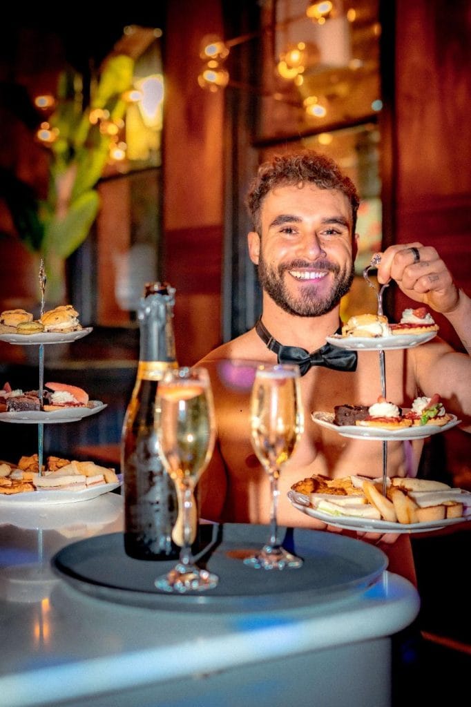 Buff butler carrying afternoon tea stands at the bottomless brunch in Leeds