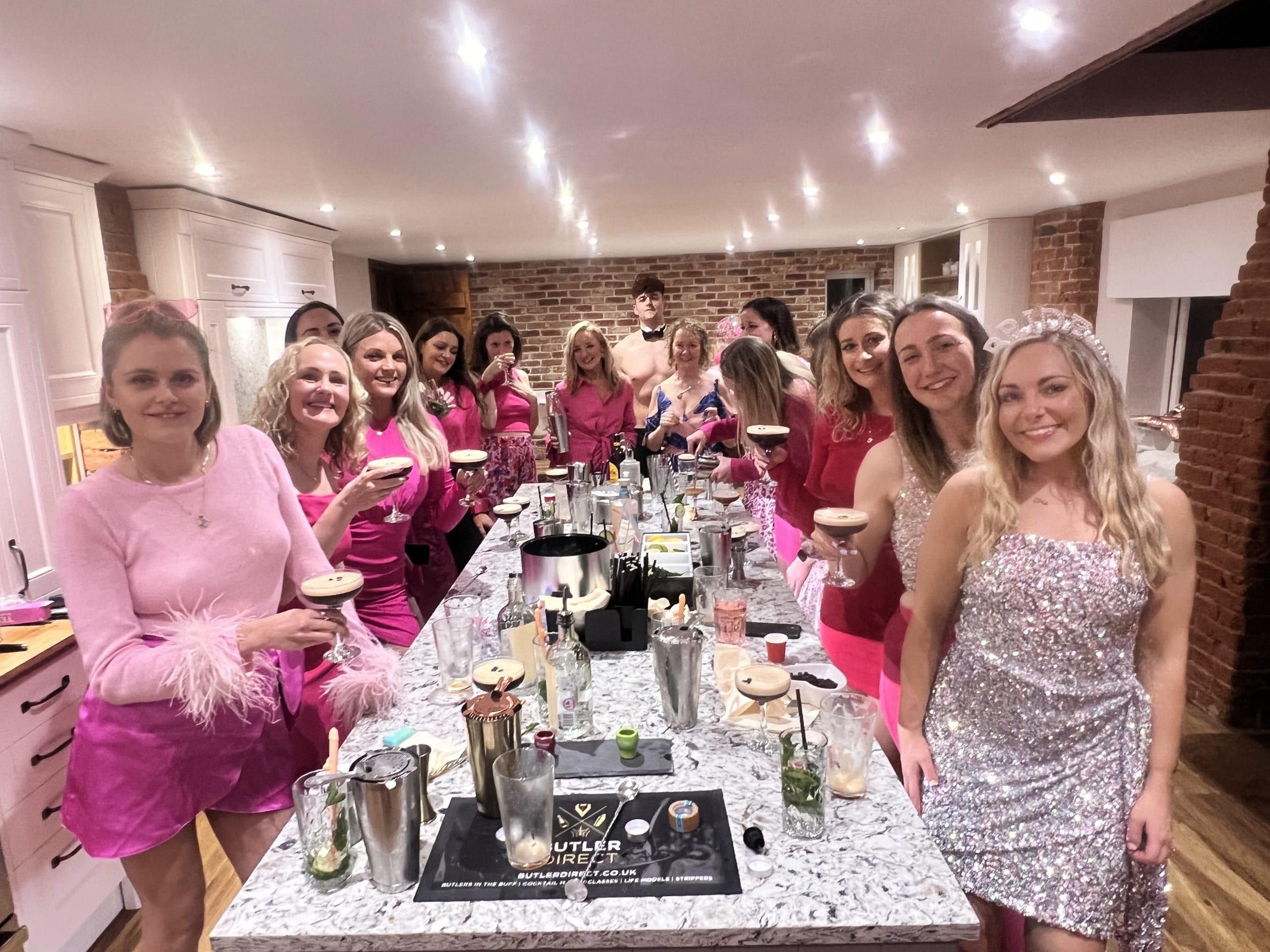 Hen party making espresso martinis with a butler in the buff